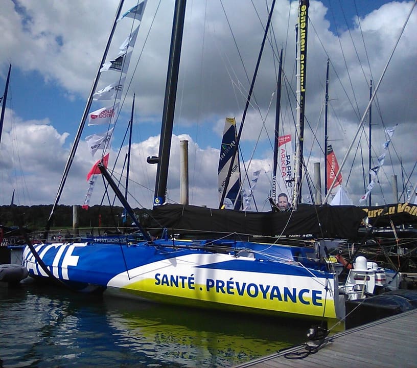An IMOCA moored at Lorient La Base before The Transat CIC 2024